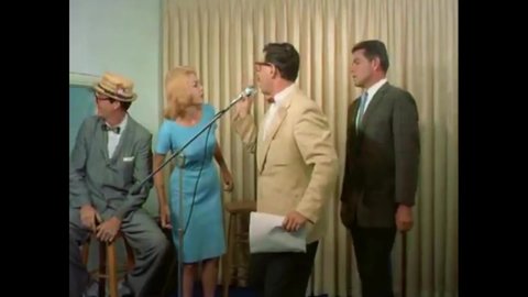 CIRCA 1963 - A couple gets into an argument over the woman's nudism while recording a radio advertisement for their nightclub.