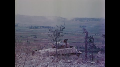 CIRCA 1945 - US Marines fire tanks on a smoky Okinawa.