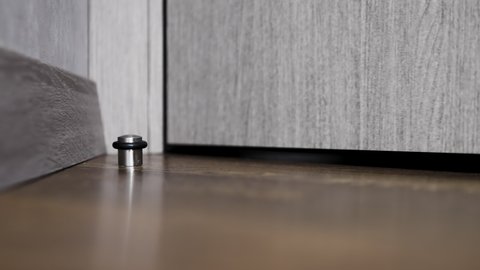 Door stopper in the interior of the apartment. Stop the door with a chrome plug