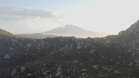 Aerial shot of the clouds over the megalithic complex of Argimusco in Sicily on the Nebrodi. Etna view and mystical scenery in Sicily. Sunset on the Argimusco Megaliths.
