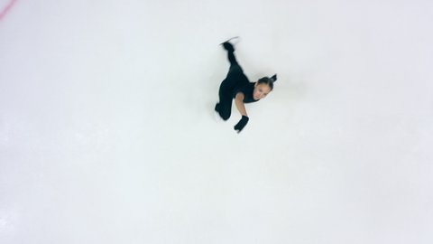 Figure skater is doing skating elements in a top view