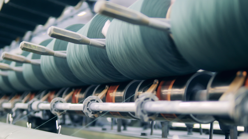 Sewing spools managed by a factory machine in a close up Royalty-Free Stock Footage #1081876547