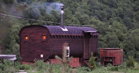 Round wooden outdoor sauna (bathhouse)outdoors in the forest.