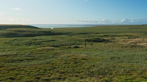 Amazing view of wild nature in Yamal peninsula. Two unrecognizable scientists examin ground. Hydrologists work