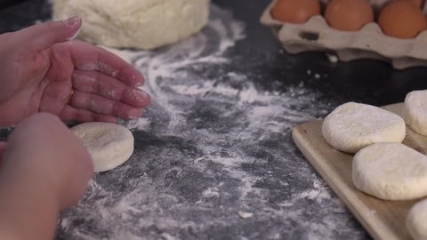 Close up of a woman making rolls and spreading dough, home cooking concept