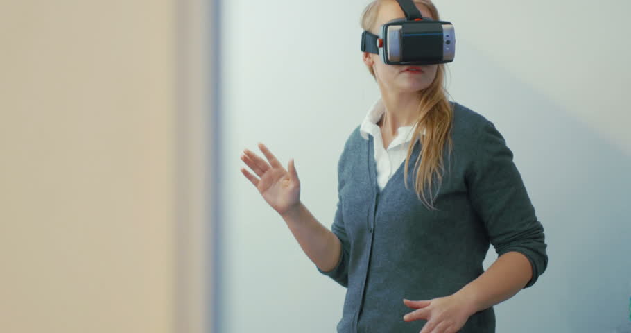 Young blonde woman playing game using VR-helmet for smart phones. Augmented reality device allows to deep into virtual space Royalty-Free Stock Footage #10818857