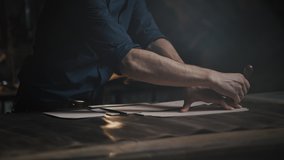 Garment production process. Unrecognizable male tailor passing around patterns on leather piece, preparing blanks for making shoes, slow motion - Powered by Shutterstock - Get 15% off with code: PIKWIZARD15