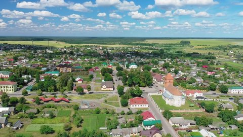 "Mir" is a town in the Karelichy District of Grodno Region.  Aerial view.  Landscape Of Village Houses. Catholic Church of St. Nicholas on background of blue sky. Mir,Belarus