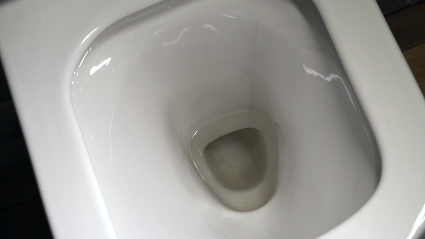 Flush toilet. Water flushes the toilet. Water saving concept. Slow motion Royalty-Free Stock Footage #1081902725
