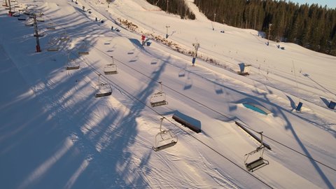 Aerial of prepared ski slopes at sunrise before opening. 4K drone footage.