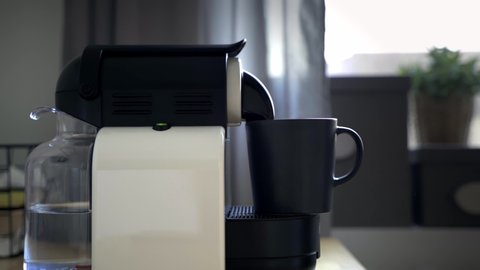 Making a cup of coffee with a coffee machine