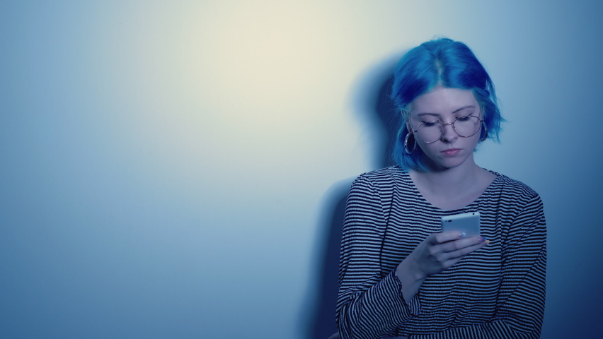 Cyber bullying. Phone lonely. Internet harassment. Sad depressed woman victim received cell hater abuse message isolated on light gradient empty space background. | Shutterstock HD Video #1081921520