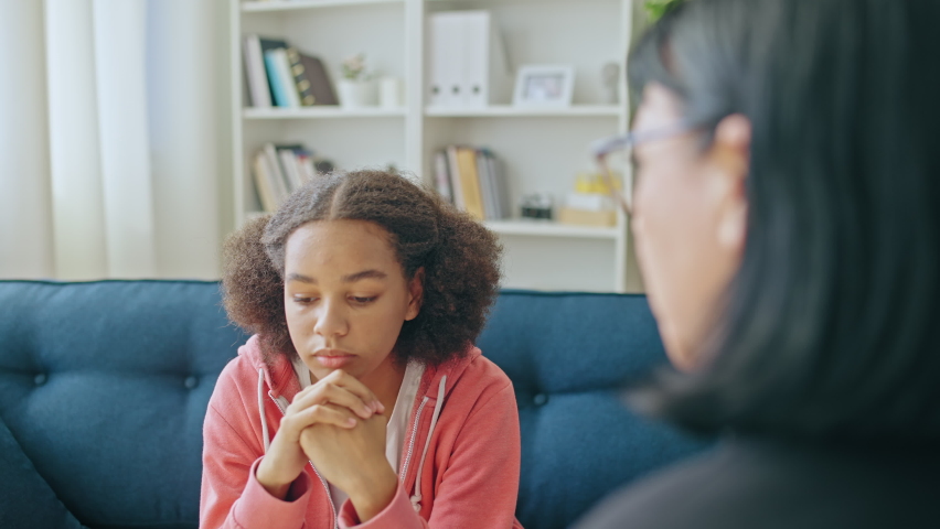 Teenager talking to female psychologist, adolescent counseling, mental health