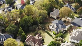 4k aerial video of an upscale neighborhood with beautiful houses shot during the fall of 2021