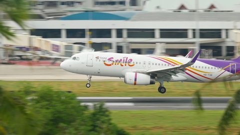 PHUKET, THAILAND - NOVEMBER 30, 2016: Airbus 320 of Thai Smile HS-TXR landing, touching the runway and braking. Phuket International Airport. Thai Smile Thai regional airline