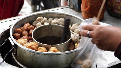 Pentol is a type of snack which can be found in Indonesia - it's a type of meatballs with flour, usually given with peanut sauce or tomato sauce, soy sauce and sambal. Bakso or baso is an meatball.