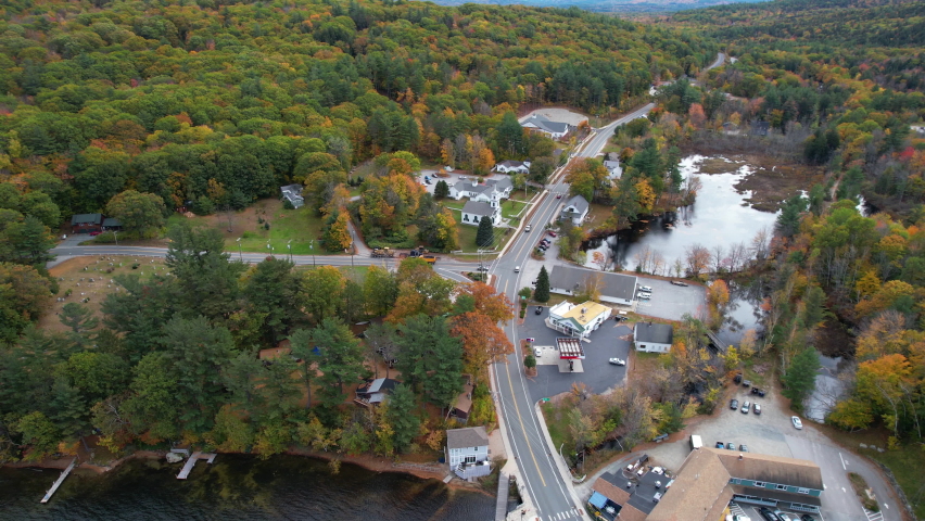 Town of Newbury, New Hampshire USA. Aerial View of Buildings and Road by Sunapee Lake in Colorful Autumn Forest Foliage, Drone Shot