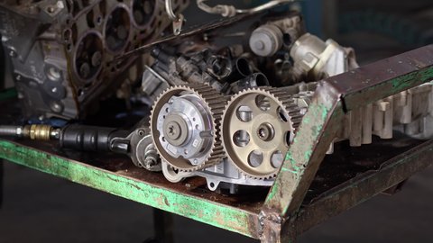 Car Master Checks Camshaft Of Car Engine In Repair Shop