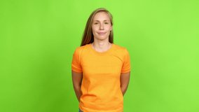 Young blonde girl with happy face over isolated background. Green screen chroma key