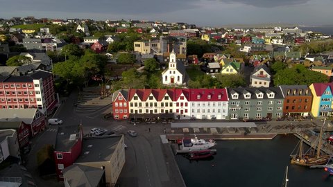 Mikladalur, Mikladalur, Faroe Islands - 10 10 2021: Beautiful aerial view of the City of Torshavn Capital of Faroe Islands- View of Cathedral, colorful buildings, marina, suburbs and Flag