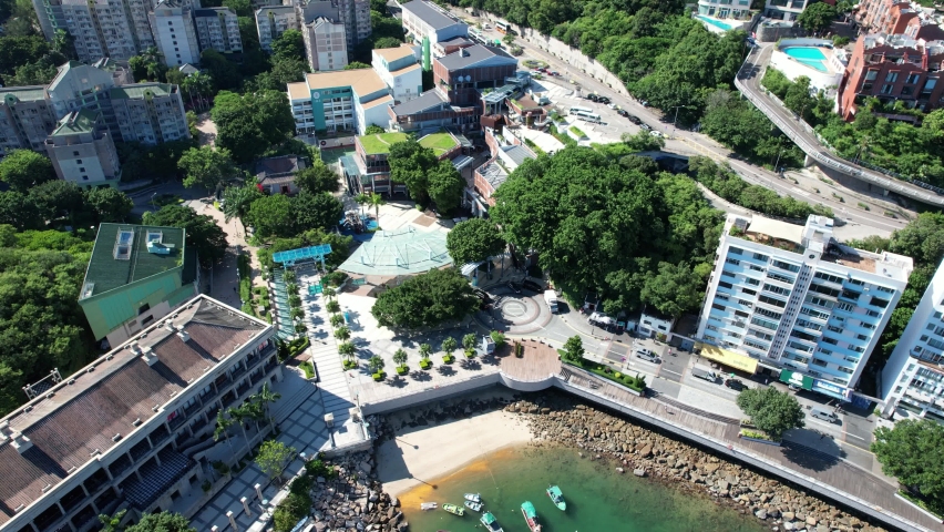 Stanley Market, a coastal town of Hong Kong, with traditional villages, beautiful scenery, water activities, beaches and islands, sea bay, pier and boats in-shore, aerial view