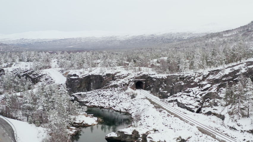 Snowy Train Tracks In The Countryside Of Dovre, Innlandet County, Norway - aerial drone shot