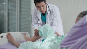 In a hospital, an orthopedic doctor examines a senior man's knee as he lies in a hospital bed. A doctor examines an elderly man's knee. - Powered by Shutterstock - Get 15% off with code: PIKWIZARD15