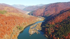 A drone flies over a beautiful lake littered with household waste. Bird's eye view. Carpathian mountains, Ukraine, Europe. Cinematic aerial shot. Environmental pollution problems. Filmed 4k video.