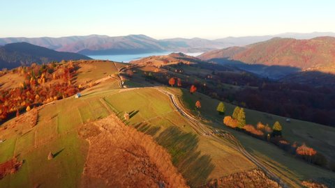 Gorgeous autumn day in the mountains from a bird's eye view. Shooting from a quadcopter. Carpathian mountains, Ukraine, Europe. Cinematic aerial shot. Beauty of earth. Filmed in 4k, drone video.