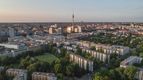 Establishing Aerial View Shot of Berlin, Germany, Alexanderplatz, capital city, track left, soft sunset, light reflections in post communistic buildings