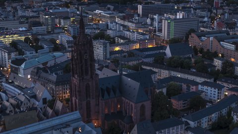 Frankfurt, Germany - circa 2021; Frankfurt Cathedral, Establishing Aerial View Shot of Frankfurt am Main De, financial capital of Europe, Hesse, Germany at night evening, circling movement