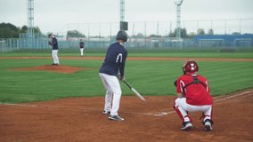College sports, guys play baseball, the pitcher throws the ball towards the batter, batter successfully hits the fastball and run to base. - Powered by Shutterstock - Get 15% off with code: PIKWIZARD15