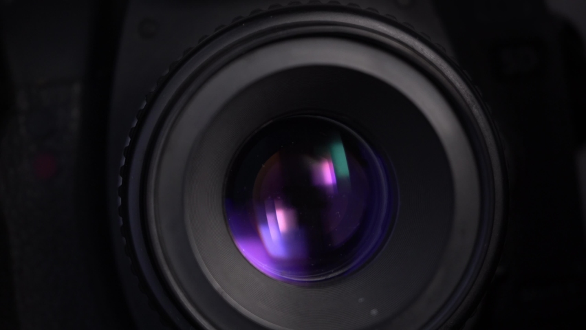 Close-up footage of aperture adjusting in a camera: diaphragm blades of a fixed lens closing and opening.  Royalty-Free Stock Footage #1081959176