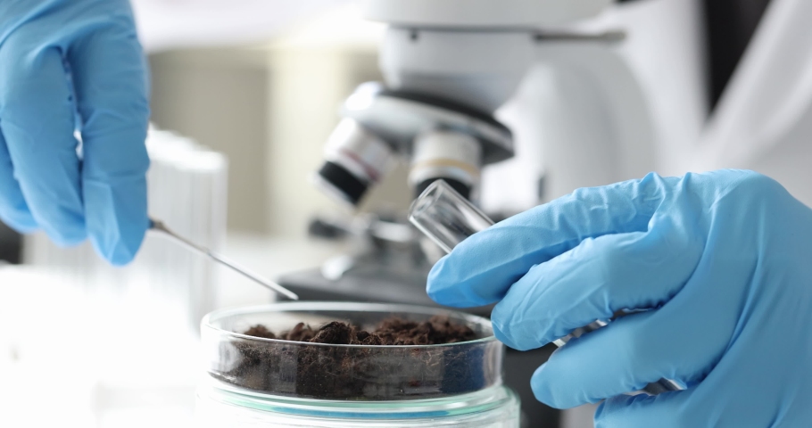 Scientist in gloves puts soil samples in test tube for research slow motion 4k movie | Shutterstock HD Video #1081960949