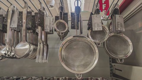 MILAN, ITALY 5 NOVEMBER 2021: Kitchen accessories. Tools for cooking. Black kitchen turner skimmer ladle and Kitchen stainless steel turner skimmer ladle.