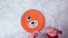 Step by step video instruction: how to make Tiger from Paper Plate. STEP 4