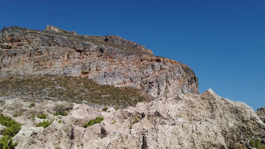 Rocks, mountain against the blue sky. Parallax effect, camera stabilized. Amazingly beautiful landscape of the island of Crete, Greece.
