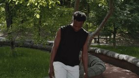 Sporty African American Man Juggling A Soccer Ball Training Outdoors In Park, Wearing Sportswear. Sport Lifestyle, Hobby And Weekend Leisure Concept. Tracking Shot