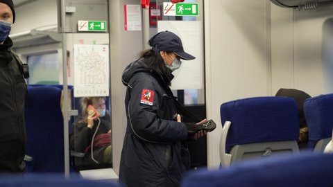 Contractor in a suburban train. Checking tickets, mack control. NOW 5 2021 MOSCOW RUSSIA