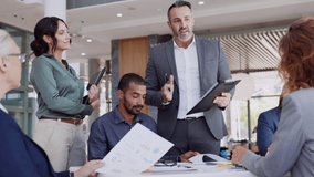 Successful entrepreneur focusing on work with charts during meeting with multiethnic employee. Mature businessman discussing work at conference table in office with senior businesswoman. - Powered by Shutterstock - Get 15% off with code: PIKWIZARD15