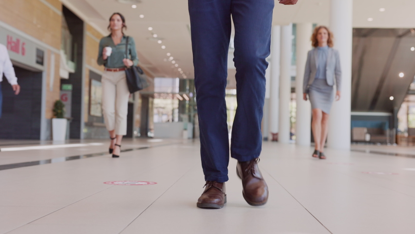 Proud business man walking in office hallway, framing from low to high point of view. Smiling mixed race man walking in workplace corridor with positive expression. Royalty-Free Stock Footage #1081987010