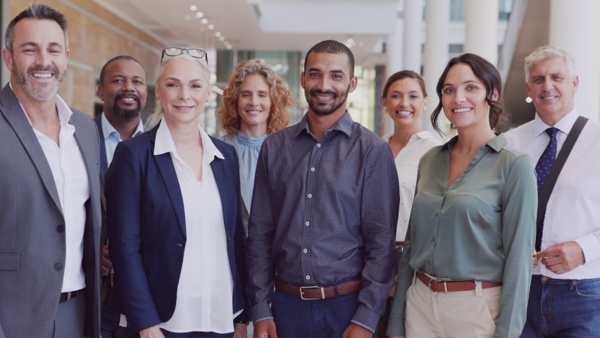 Group of happy multiethnic business people smiling and showing sign of success. Successful business team showing thumbs up and looking at camera. Portrait of proud businessmen and businesswomen. | Shutterstock HD Video #1081987013
