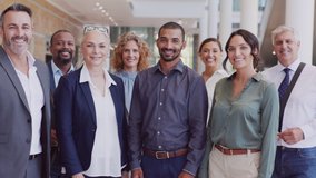 Group of happy multiethnic business people smiling and showing sign of success. Successful business team showing thumbs up and looking at camera. Portrait of proud businessmen and businesswomen. - Powered by Shutterstock - Get 15% off with code: PIKWIZARD15
