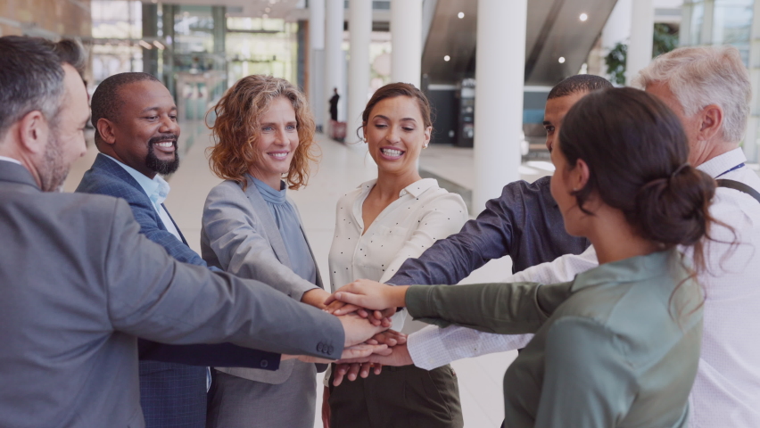 Multiethnic business people stacking hands in modern office and cheering together. Successful business team stacking hands with each other. Office colleague joining together to celebrate a success. Royalty-Free Stock Footage #1081987016