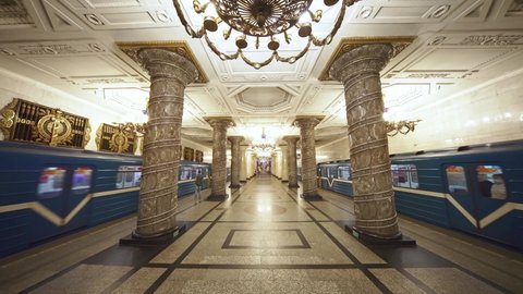 SAINT PETERSBURG, RUSSIA - JUNE 18, 2021: Metro train leaving iconic soviet architecture subway station in in Saint Petersburg, Russia. Historic tourist attraction, soviet russian architecture.  