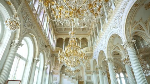 SAINT PETERSBURG, RUSSIA - JUNE 18, 2021: Crystal golden chandeliers. Interior of Hermitage museum, Winter Palace, Saint Petersburg. Famous art, culture landmark, major tourist attraction in Russia. 