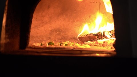 the chef in the kitchen lays out the filling for a traditional Neapolitan pizza
