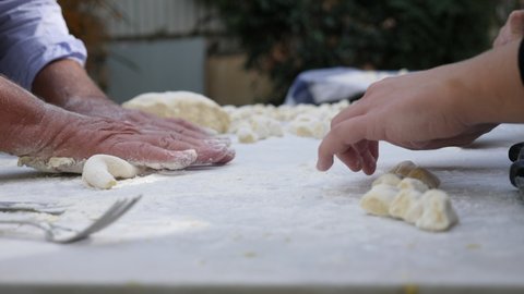 Hands preparing the gnocchi, a typical first course of the Italian tradition
Preparation of potato gnocchi, a typical dish of Italian cuisine