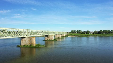 The pedestrian bridge of Sully sur Loire in Europe, in France, in the Center region, in the Loiret, in summer, on a sunny day.