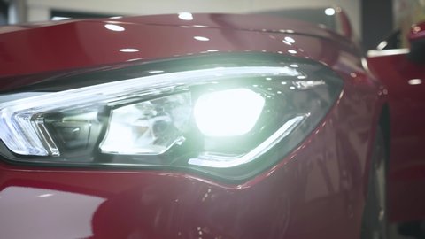 Close up of details of headlights of anonymous prestigious black luxury modern car. Concept of passion for driving cars, car dealerships,luxury cars. Shot in 4K. Head light.